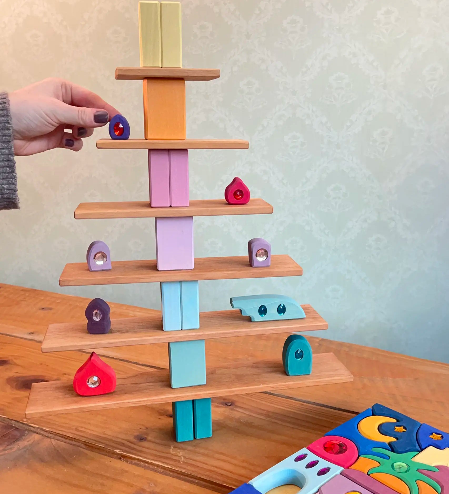 A tree structure made from Grimms wooden natural building boards and other pastel building blocks