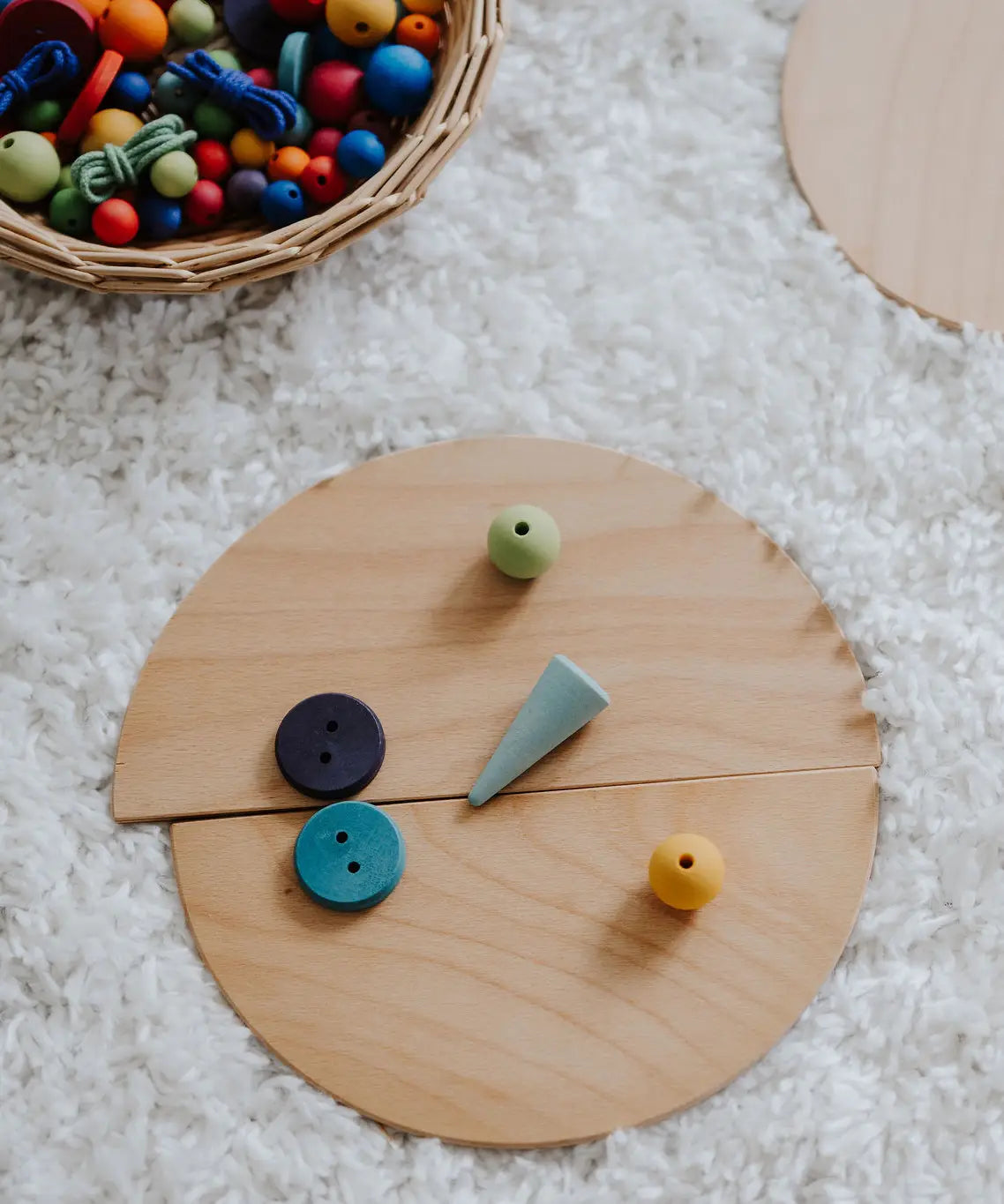 A abstract looking face made loose Grimm's natural wooden semi circle pieces and other loose blocks