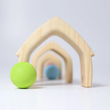 Front of Grimms wooden natural house pieces lined up with a pastel ball in front showing scale