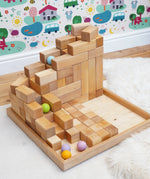  A ball run made from the Grimms natural large stepped pyramid and  pastel wooden balls in the Babipur playroom
