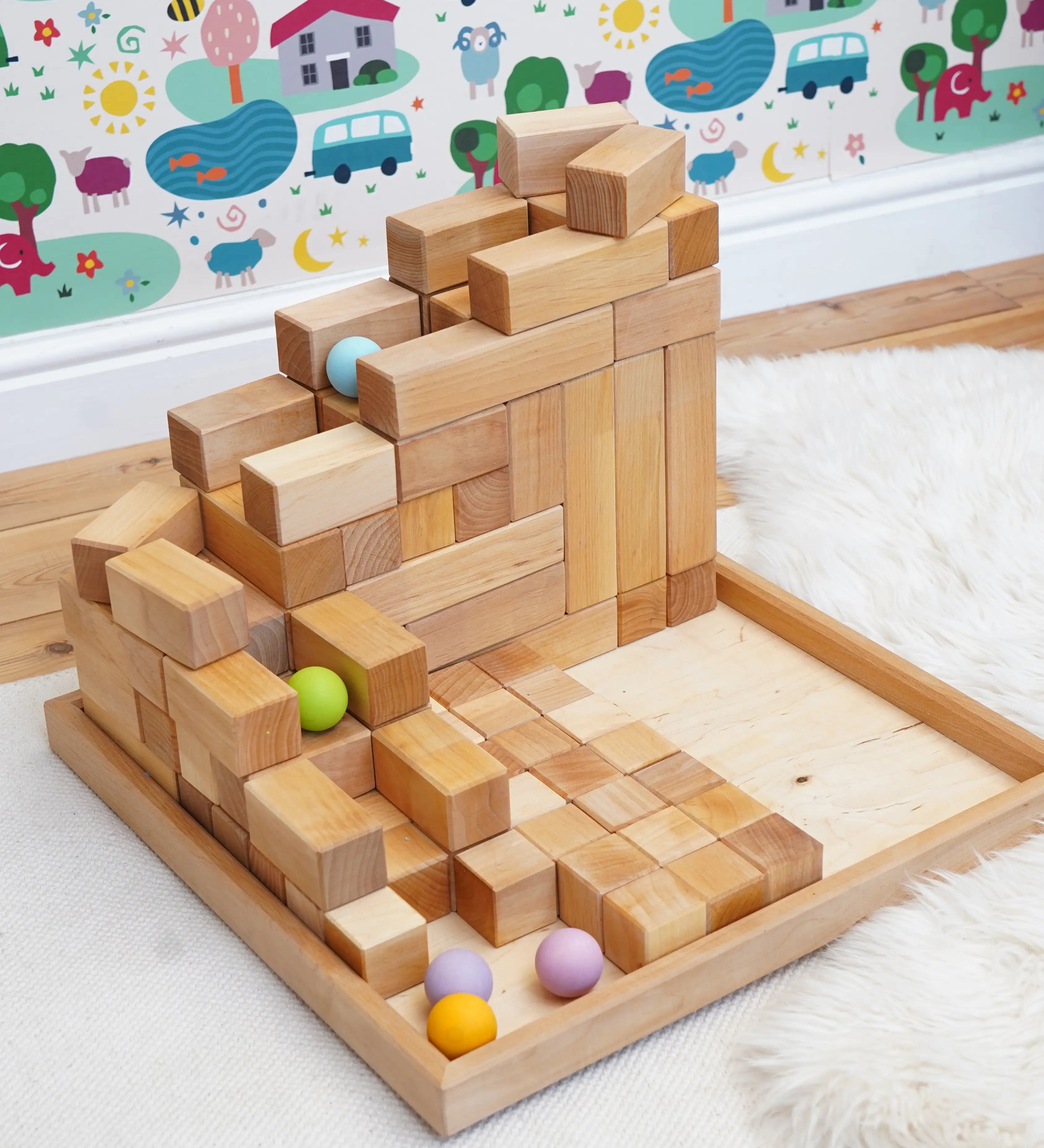 A ball run made from the Grimms natural large stepped pyramid and  pastel wooden balls in the Babipur playroom