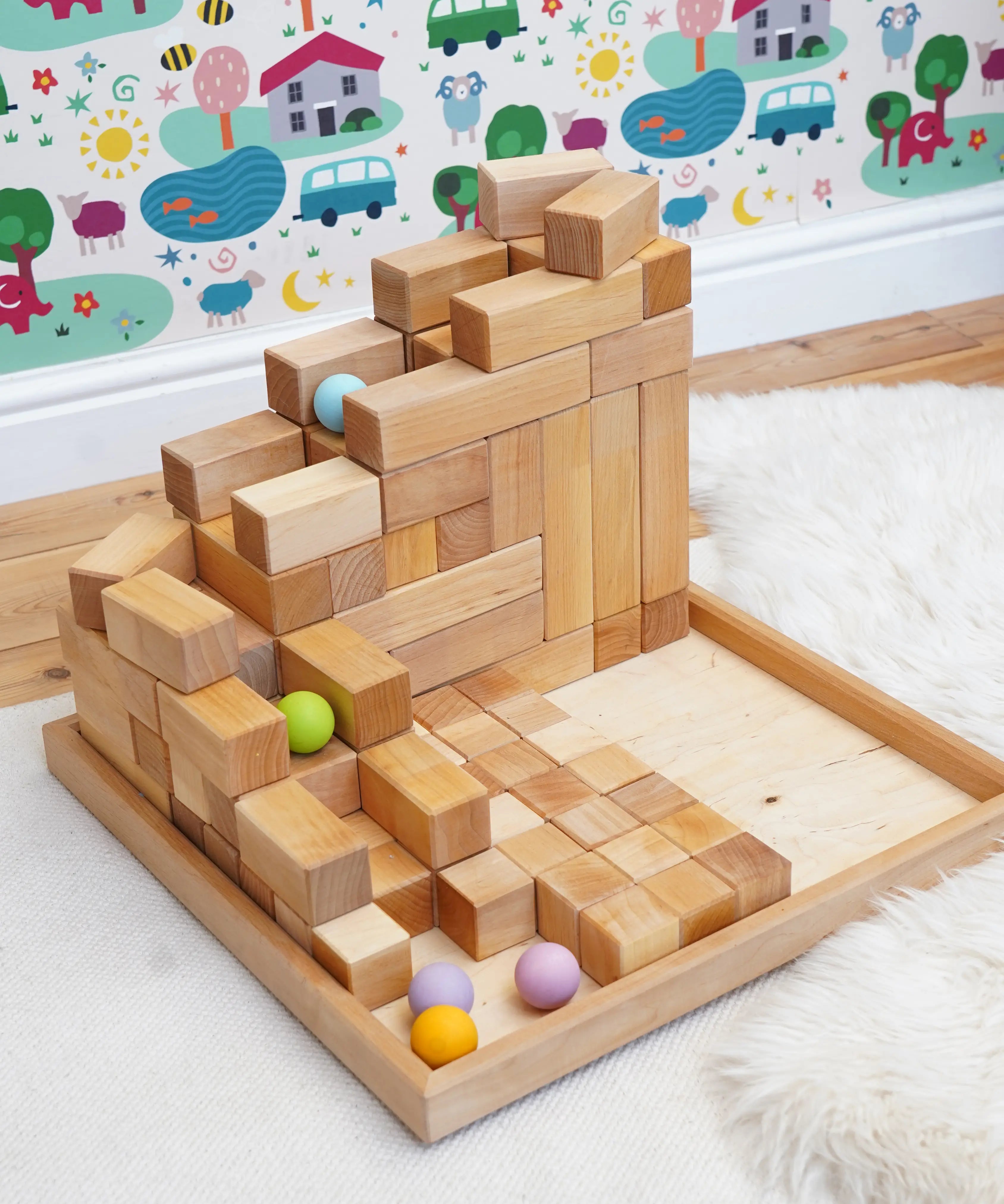  A ball run made from the Grimms natural large stepped pyramid and  pastel wooden balls in the Babipur playroom