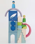 A beautiful play scene of a front of a house using the wooden try as a backdrop and the gems attached to the try like stars. The arch blocks are carefully balanced on top of the tray