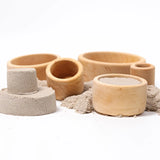 Grimms natural wooden bowls with sand inside them