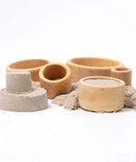 Grimms natural wooden bowls with sand inside them