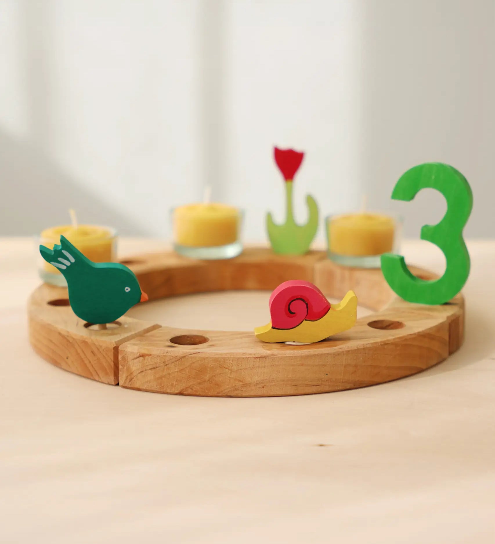 Grimm's handcrafted celebration ring with a pecking bird, pink snail, and a number 3 decorative figure 