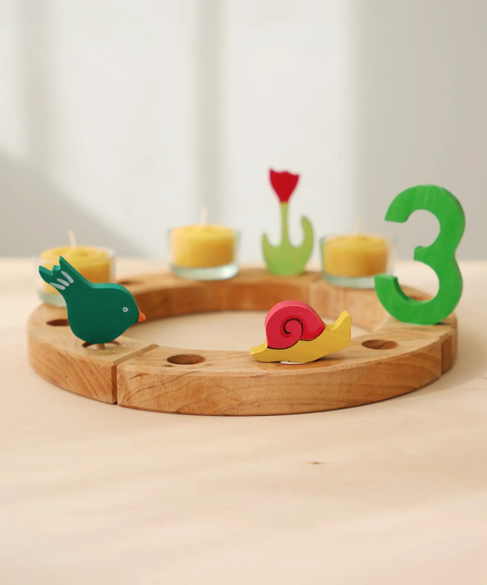 Grimm's handcrafted celebration ring with a pecking bird, pink snail, and a number 3 decorative figure 