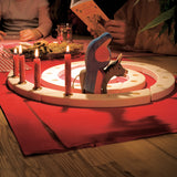 A Grimm's Natural Wooden Spiral set up on a table decorated with red Grimm's candles in brass holders and an Ostheimer donkey and Mary wooden figure. 