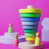 Inverted stack using wooden pieces from the Grimms neon green conical tower standing next to neon peg dolls.