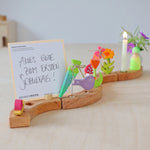 Grimm's Sweet Cone Decorative Figure - Neon Green. The cone sits inside the Celebration ring alongside other Grimm's figures.