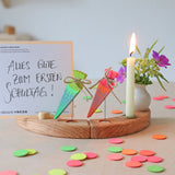 Grimm's Sweet Cone Decorative Figure - Neon Green. The cone sits inside the Celebration ring alongside the Neon Pink Cone and a candle.