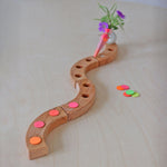 Grimm's Neon Celebration Confetti Dots. The dots sit on top of a celebration ring on a wooden table.