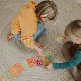Children sorting the Grimms number cards showing each card with corresponding number of illustrated animals