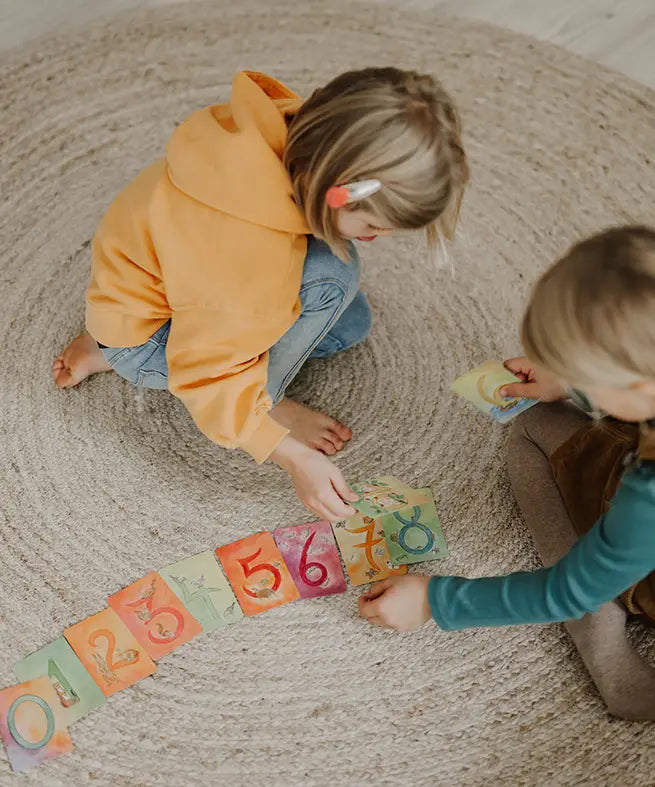 Children sorting the Grimms number cards showing each card with corresponding number of illustrated animals