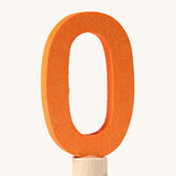 An orange coloured number zero Grimm's Decorative Number figure to fit a Grimm's celebration ring. These numbers are part of a large range of decorative figures available here at Babipur. 