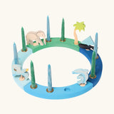 Grimm's handcrafted wooden celebration ring displayinga boat, two dolphins, seagull, elephant and a palm tree decorative figure