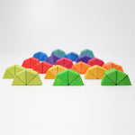 The triangluar shaped blocks from the Grimm's Octagon Puzzles shown stacked together in groups of 4 to create semi circles. 
