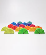 The triangluar shaped blocks from the Grimm's Octagon Puzzles shown stacked together in groups of 4 to create semi circles. 