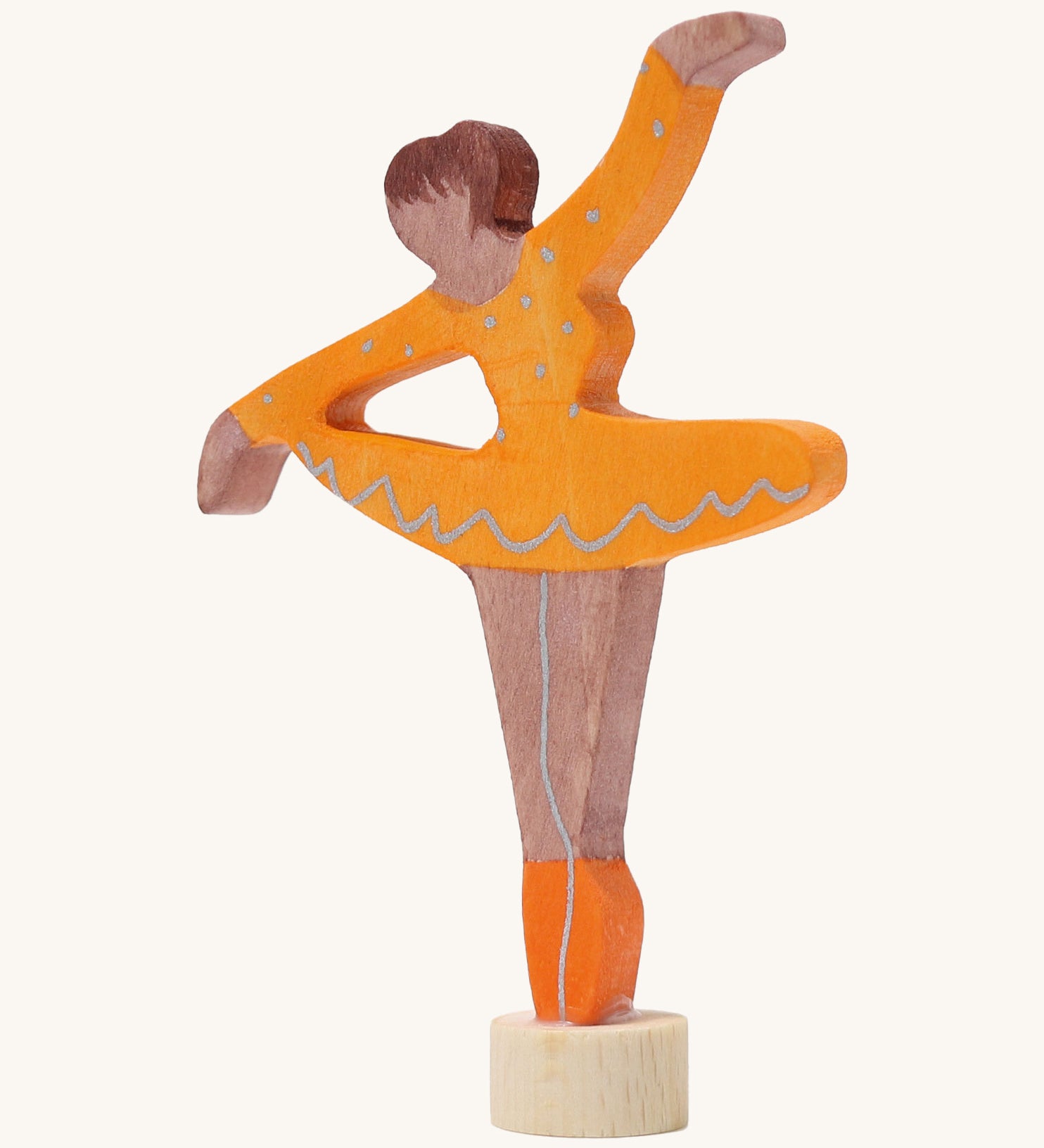 A Grimms wooden ballerina decorative figure in orange. Features a small base on the bottom to slot into the celebration ring.