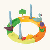 Grimm's handcrafted wooden celebration ring displaying various decorative figures including a tree, swan, flowers, fish and duck