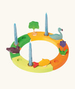 Grimm's handcrafted wooden celebration ring displaying various decorative figures including a tree, swan, flowers, fish and duck
