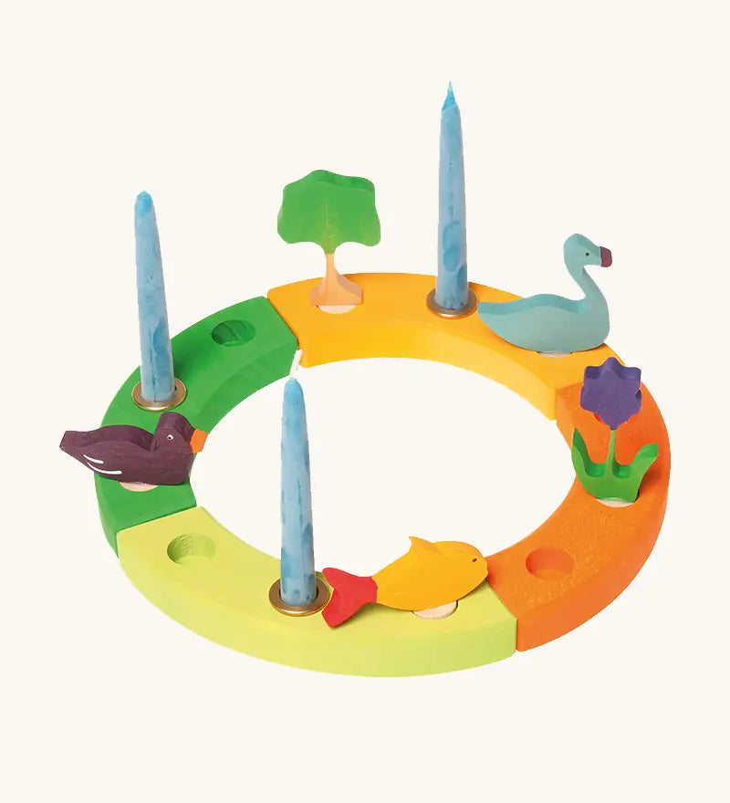 Grimm's handcrafted wooden celebration ring displaying various decorative figures including a tree, swan, flowers, fish and duck