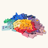 Pieces from the Grimm's orient sparkling building set wooden toy laid out.