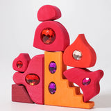 Red and orange pieces from the Grimm's orient sparkling building set wooden toy.