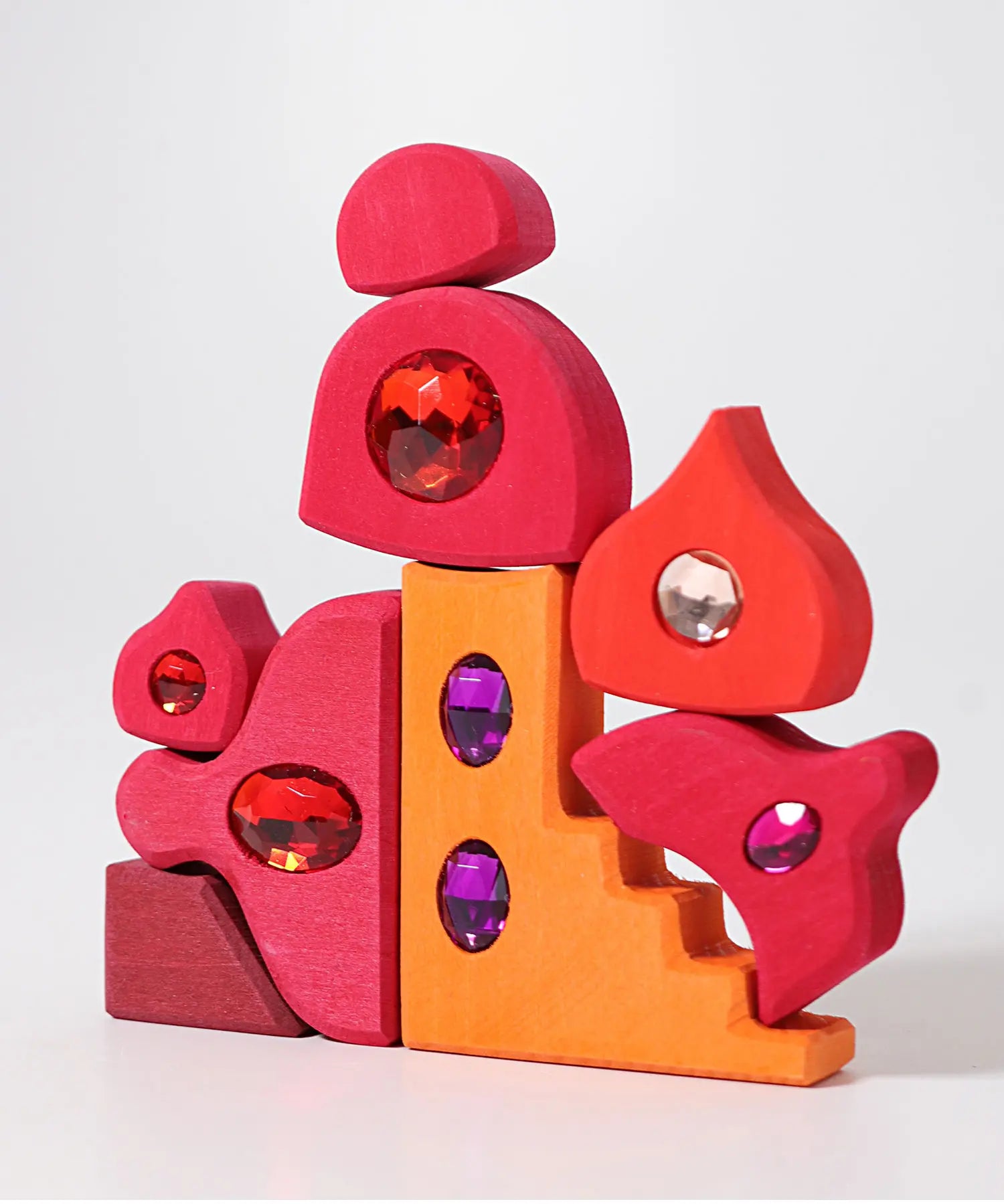 Red and orange pieces from the Grimm's orient sparkling building set wooden toy.
