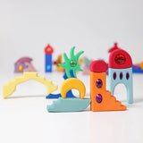 Pieces from the Grimm's orient sparkling building set wooden toy used to create a little small world play scene.
