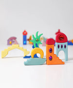 Pieces from the Grimm's orient sparkling building set wooden toy used to create a little small world play scene.