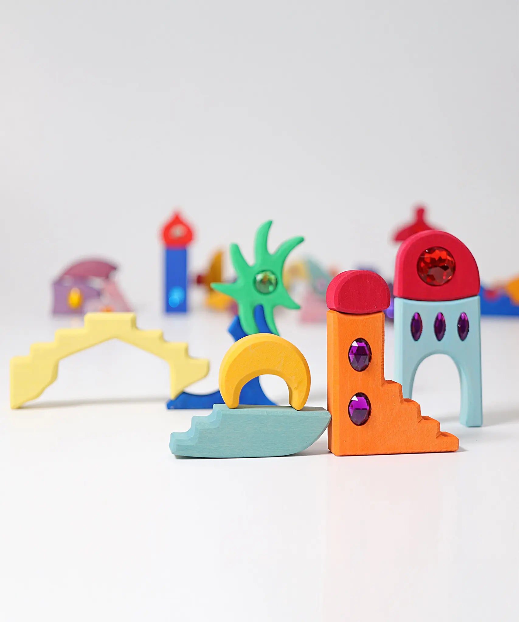 Pieces from the Grimm's orient sparkling building set wooden toy used to create a little small world play scene.