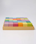 Side of a Grimms 36 cubes set in pastel colours standing in a wooden frame