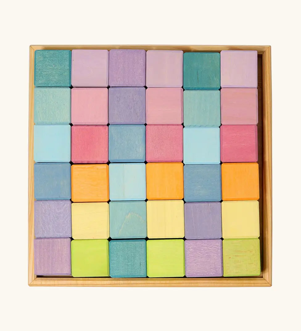 Overhead view of a Grimms 36 cube set in pastel colours standing in a wooden frame