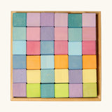 Overhead view of a Grimms 36 cube set in pastel colours standing in a wooden frame