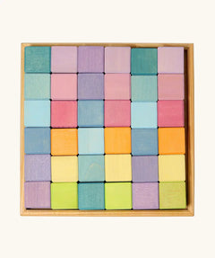 Overhead view of a Grimms 36 cube set in pastel colours standing in a wooden frame