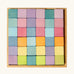 Overhead view of a Grimms 36 cube set in pastel colours standing in a wooden frame