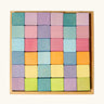 Overhead view of a Grimms 36 cube set in pastel colours standing in a wooden frame