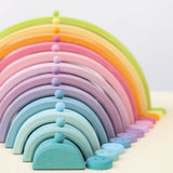 Grimms 12mm wooden beads in a pastel palette balancing on matching arched building pieces 