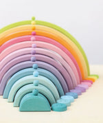 Grimms 12mm wooden beads in a pastel palette balancing on matching arched building pieces 