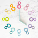 A flatlay showing a clock made from Grimms wooden pastel building boards and ring pieces