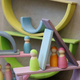 Multiple boat structure stacks made from Grimm's pastel building boards archway pieces and peg dolls