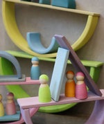 Multiple boat structure stacks made from Grimm's pastel building boards archway pieces and peg dolls