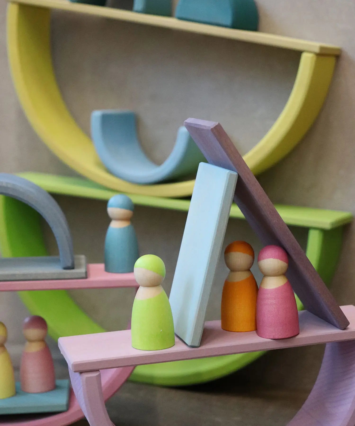 Multiple boat structure stacks made from Grimm's pastel building boards archway pieces and peg dolls