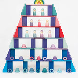 A tower structure made from a mixture of Grimms wooden pastel and rainbow building blocks 