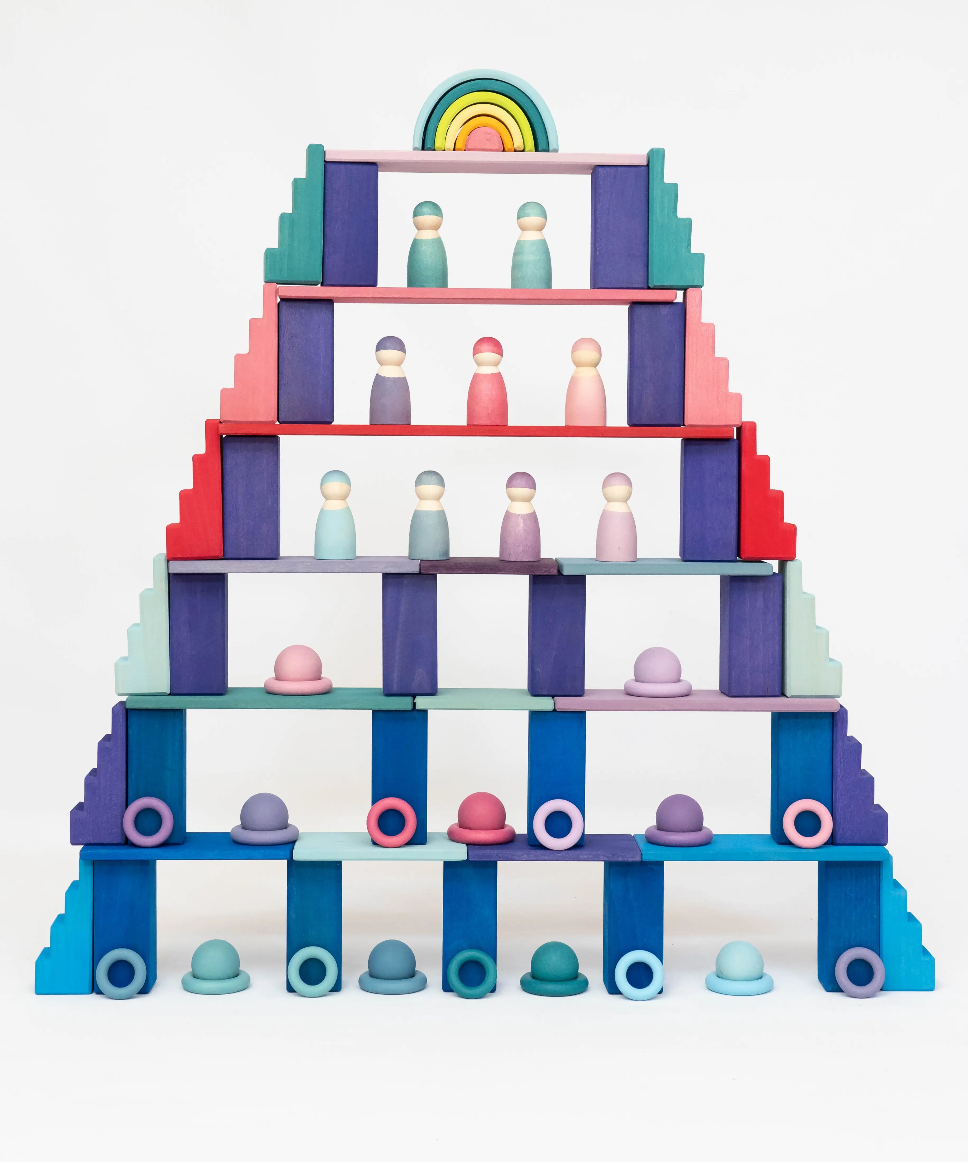 A tower structure made from a mixture of Grimms wooden pastel and rainbow building blocks 