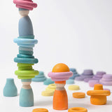 Grimms handcrafted wooden pastel coloured peg dolls with rings and half spheres stacked on top 