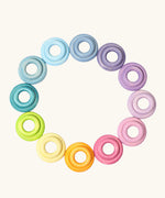 Set of 24 Grimms handcrafted wooden rings in a pastel palette in small and large sizes