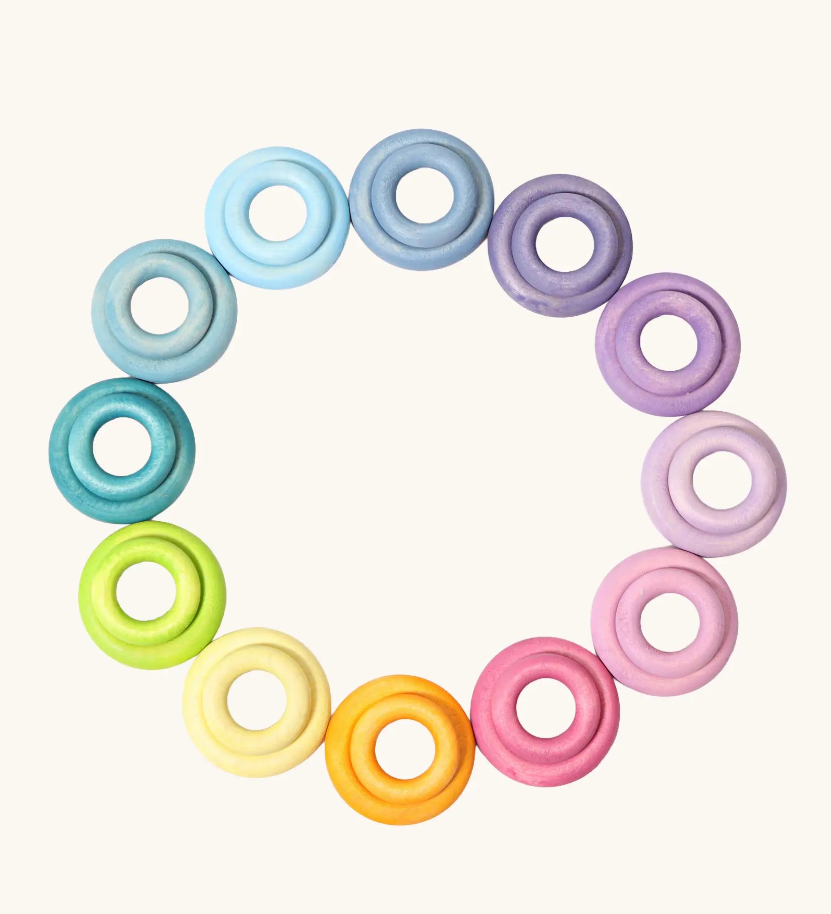 Set of 24 Grimms handcrafted wooden rings in a pastel palette in small and large sizes