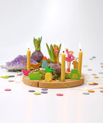 Grimms wooden celebration ring showing decorative figures, candles and pastel confetti dots